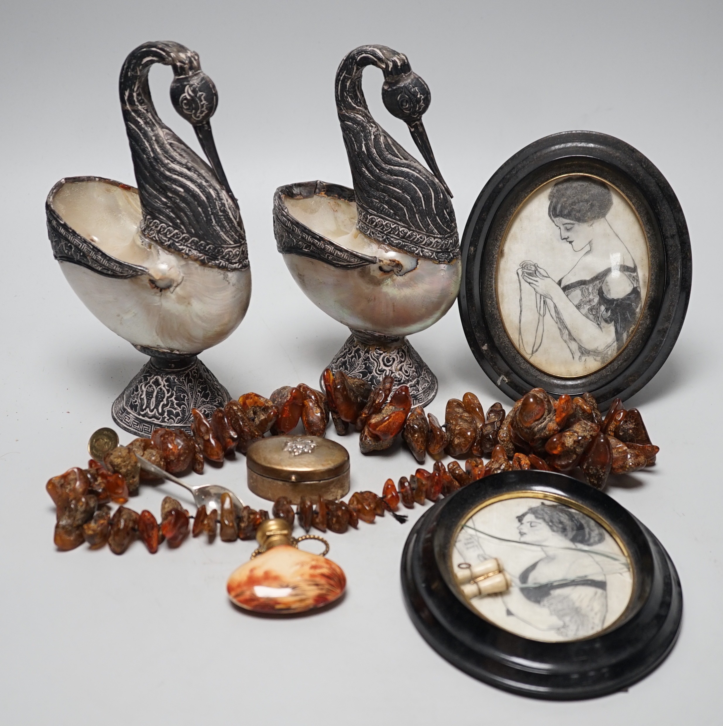 A pair of mother of pearl and silvered swan ornaments, amber and mixed collectables